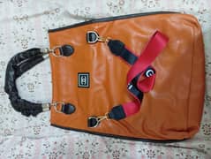 Imported tan leather bag.