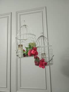 2 hanging cage with flowers, leaves and, candles