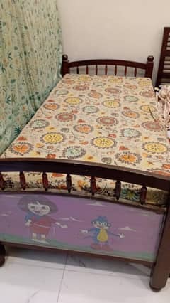 Wooden single bed with mattress