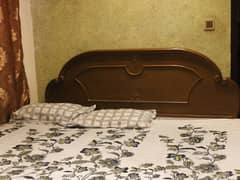 Strong wooden double bed with one side table