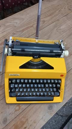 vintage 1970s Olympia sm8 yellow color typewriter