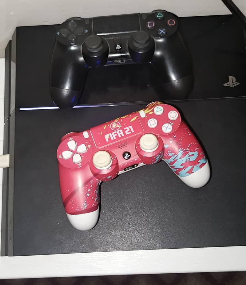 ps4 fat 1100 series with 2 controllers and games 3