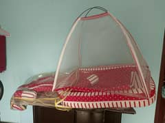 baby bed with mosquito net and pillows