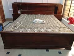 Solide double bed with attached side table and with mattress