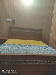 kind bed with side table