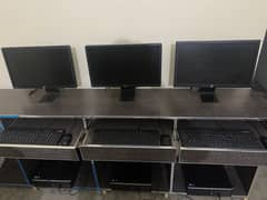 3 Lcds , 3 cpus , 3 keyboards , 3 mouse with the computer table