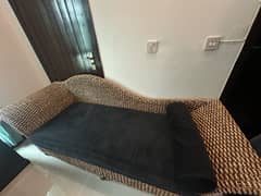 Cane three seater sofa with roll cushion.