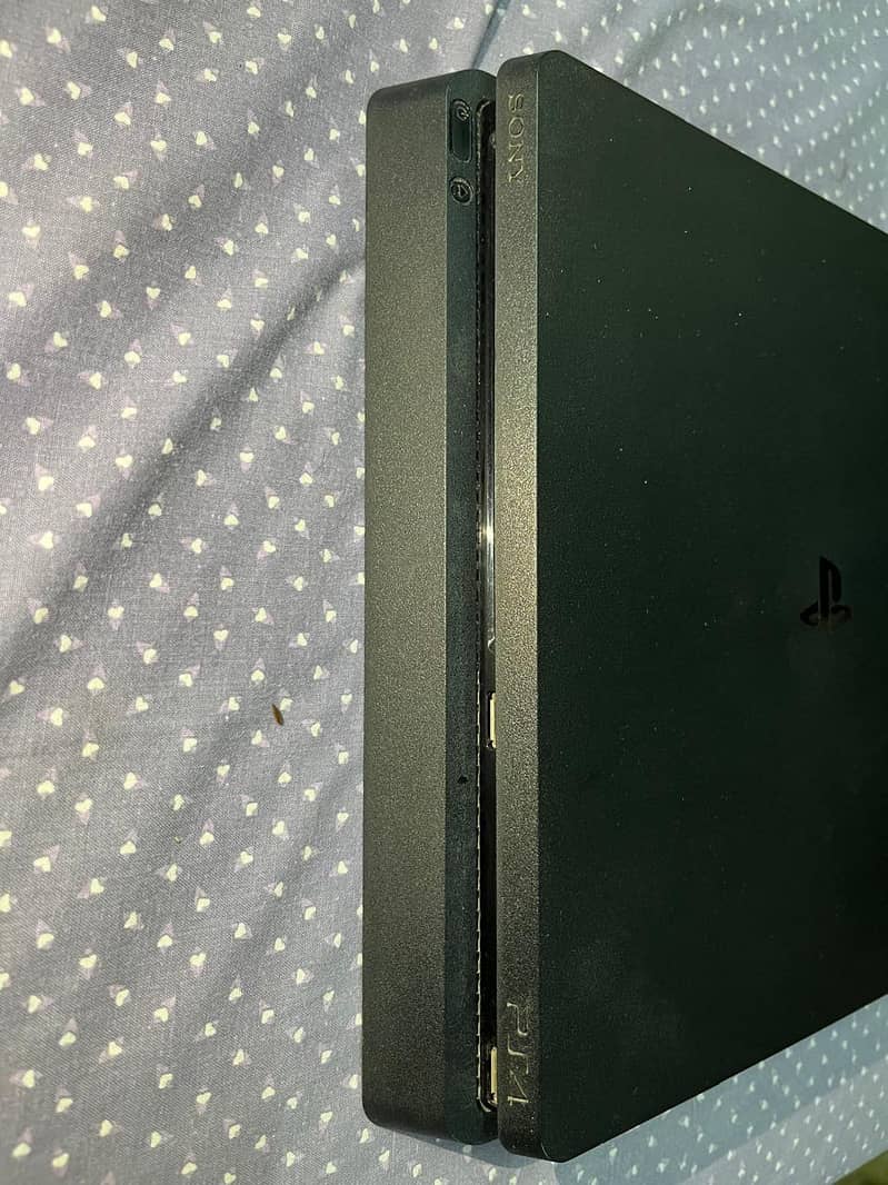 Playstation 4 slim with controllers and disks 0
