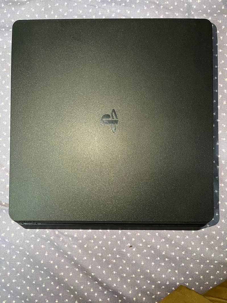 Playstation 4 slim with controllers and disks 8