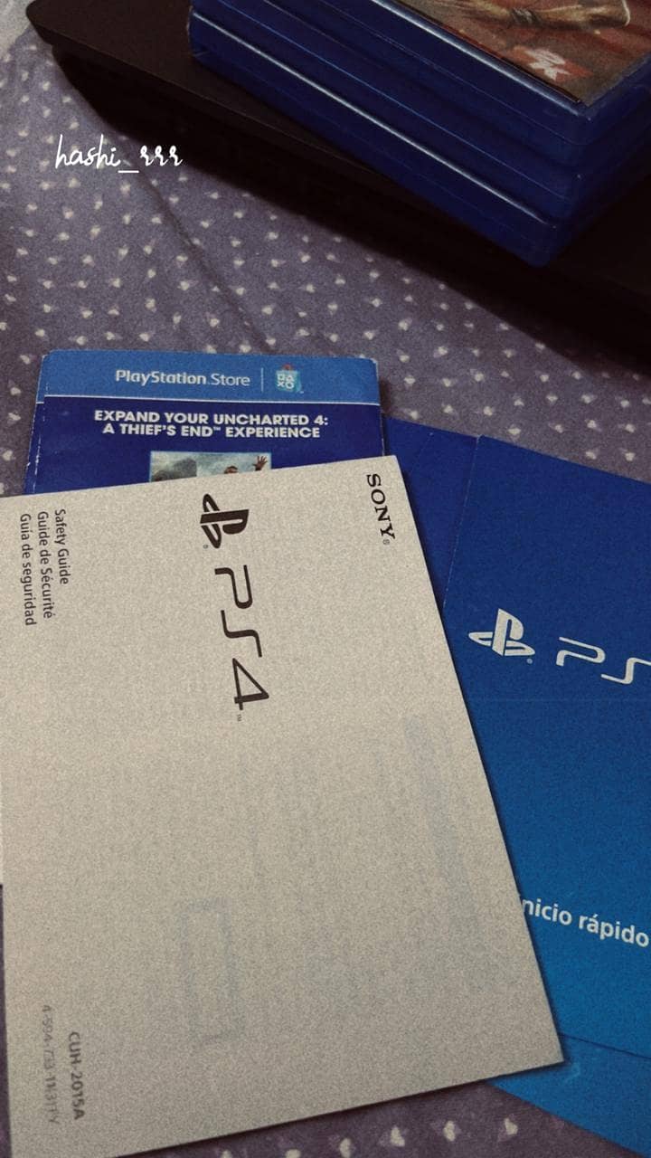 Playstation 4 slim with controllers and disks 9
