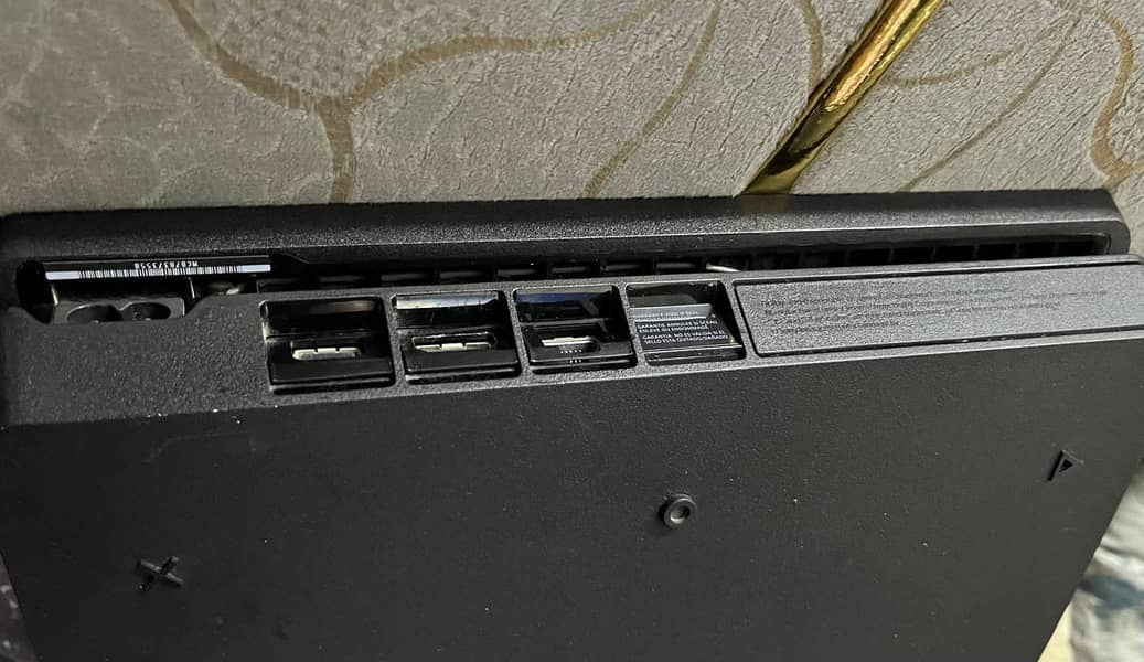 Playstation 4 slim with controllers and disks 10