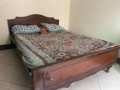 wooden bed with out mattress.