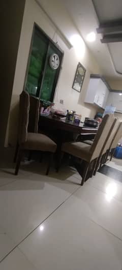Burma teak dining table with 10 dining chairs.