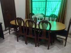 dining table with eight wooden chairs