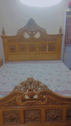 double bed with mattress and 2 side tables