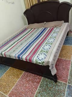 Wooden bed with mattress