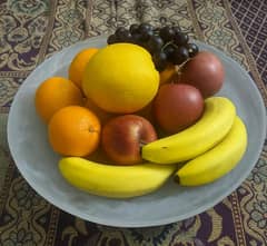 Glass or expected white marble fruit bowl.