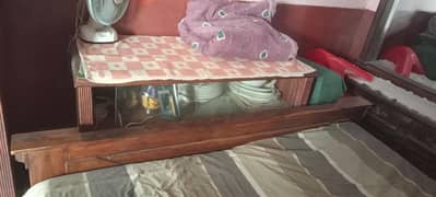 wooden bed with side table