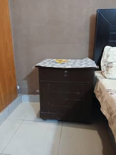 2 beds with 1 side table.