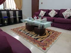 Elegant 7-Seater Sofa Set with Floral Accents and Glass Coffee Table