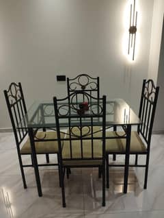 4 chairs dinning table with iron rod and tempered glass top.
