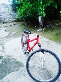 Red sports bicycle in good condition urgent sale.