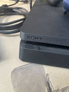 PS4 Slim with 2 controllers and 4 games CDs