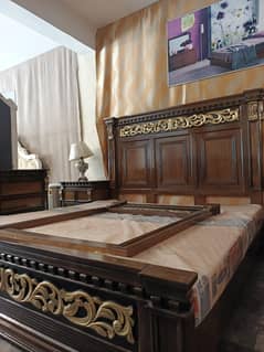 full wooden bed with golden touch
