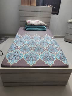 single bed without mattress and dressing table
