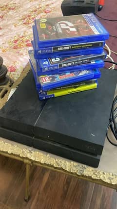 playstation 4 with games and controllers