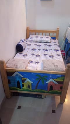 wooden beds with mattresses and wardrobe