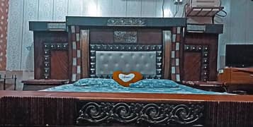 Stylish king size bed for comfortable sleeping with two side tables