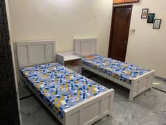 2 single beds with 2 mattress and 1 table