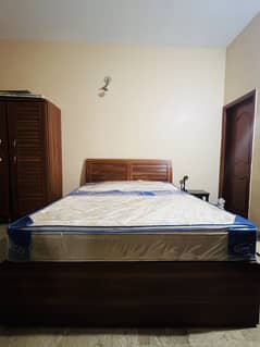 Wood bed (without mattress) and wardrobe for sale good condition