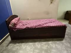 single woden bed with one side table
