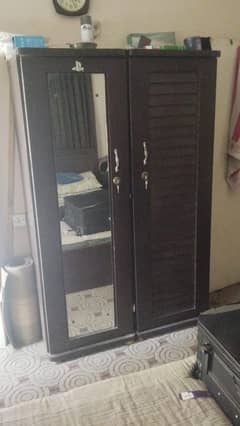black 2 door almari and an white shelf/wardrobe