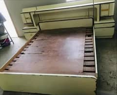 wooden bed with side drawers
