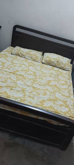 brown color medium size bed with mattress