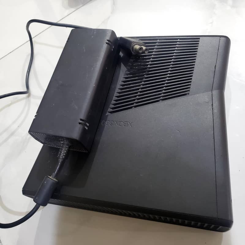 Xbox 360 slim with two controllers. 1