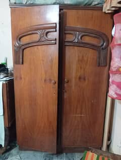 wooden cupboard with a large cabinet and a side table.