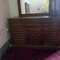 king size wooden bed with side tables and dressing table
