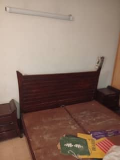 wooden bed with side table and dressing