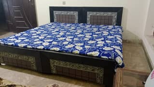 2 wooden single beds