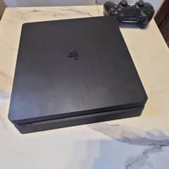playstation 4 slim with two controllers and 1 game