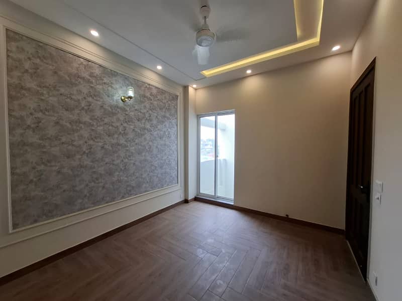 Elegant Triple-Story 10 Marla Home in DHA EME Block D with Distinct Spanish Elevation, Functional Basement with Drawing Room & Study, Separate Side Stair Access for Privacy, and High-Quality Construction by Build Force 0