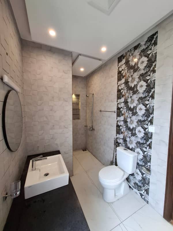 Elegant Triple-Story 10 Marla Home in DHA EME Block D with Distinct Spanish Elevation, Functional Basement with Drawing Room & Study, Separate Side Stair Access for Privacy, and High-Quality Construction by Build Force 13