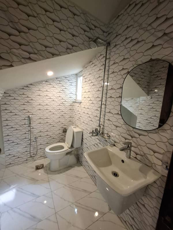 Elegant Triple-Story 10 Marla Home in DHA EME Block D with Distinct Spanish Elevation, Functional Basement with Drawing Room & Study, Separate Side Stair Access for Privacy, and High-Quality Construction by Build Force 16