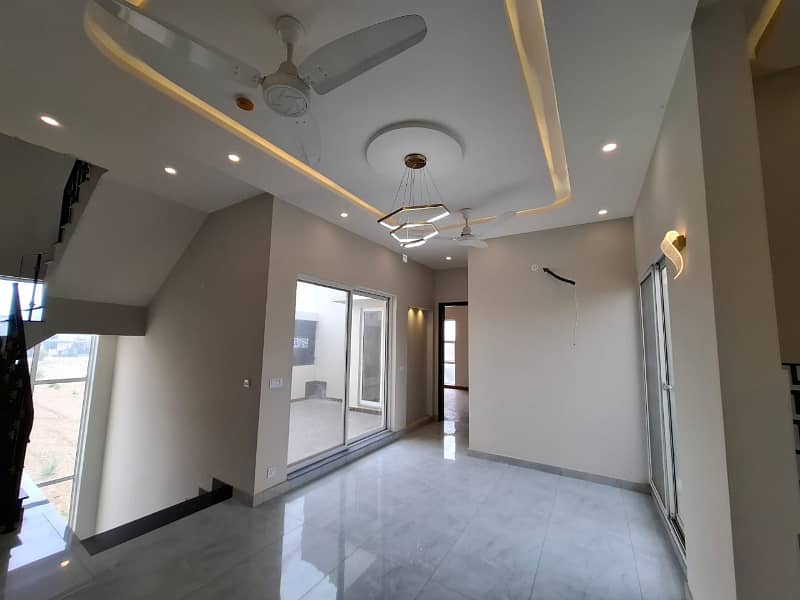 Elegant Triple-Story 10 Marla Home in DHA EME Block D with Distinct Spanish Elevation, Functional Basement with Drawing Room & Study, Separate Side Stair Access for Privacy, and High-Quality Construction by Build Force 18