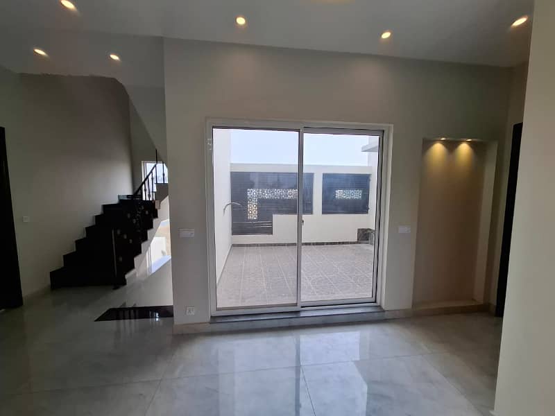 Elegant Triple-Story 10 Marla Home in DHA EME Block D with Distinct Spanish Elevation, Functional Basement with Drawing Room & Study, Separate Side Stair Access for Privacy, and High-Quality Construction by Build Force 20