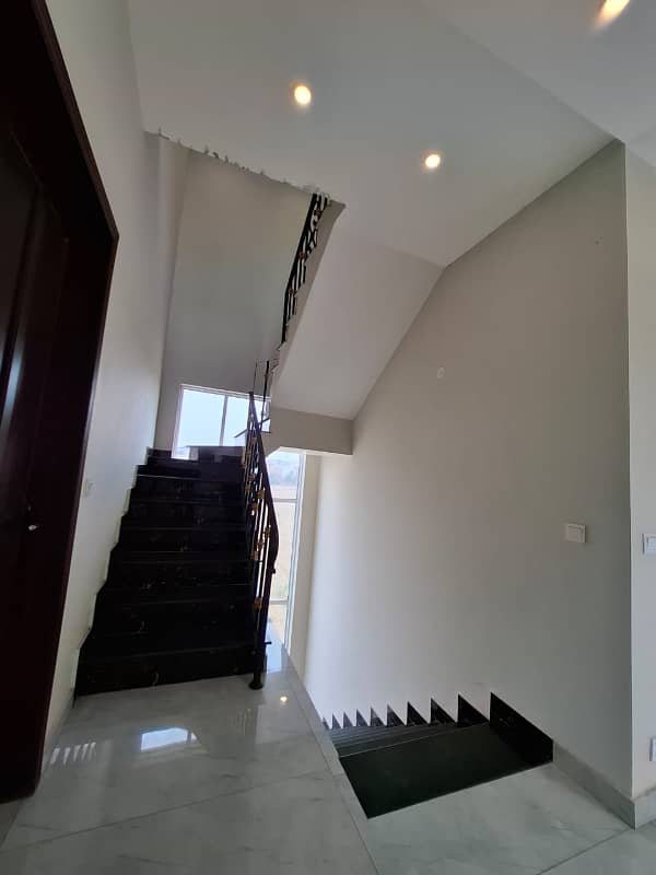 Elegant Triple-Story 10 Marla Home in DHA EME Block D with Distinct Spanish Elevation, Functional Basement with Drawing Room & Study, Separate Side Stair Access for Privacy, and High-Quality Construction by Build Force 27